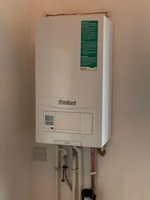 A Vaillant boiler fitted on a wall with neat copper pipework